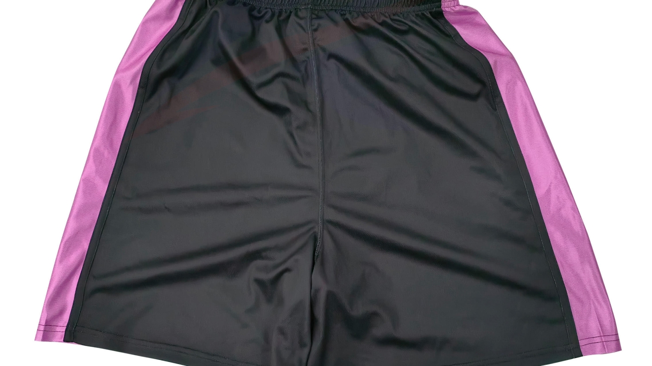 Custom black basketball shorts with pink side panels, front view