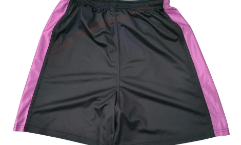 Custom black basketball shorts with pink side panels, front view